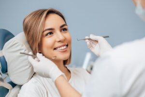 smiling patient getting her dental checkup done early in the year